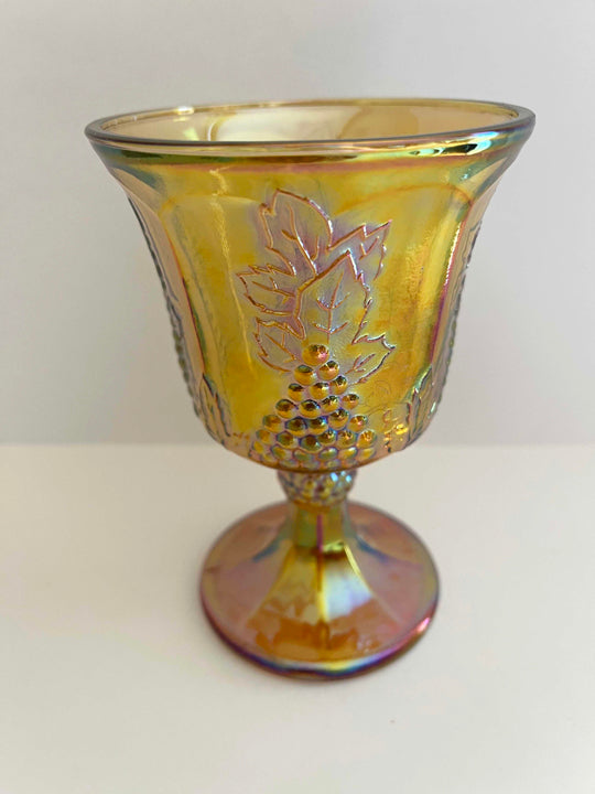 This is an Iridescent Gold Carnival Glass Goblet. It is the Harvest Pattern and the maker is Indiana Glass, circa 1972-73.