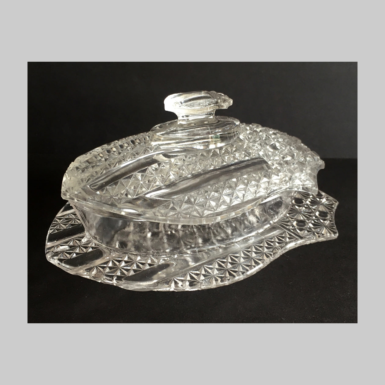 Antique clear pressed glass covered butter dish of American flag Banner pattern.