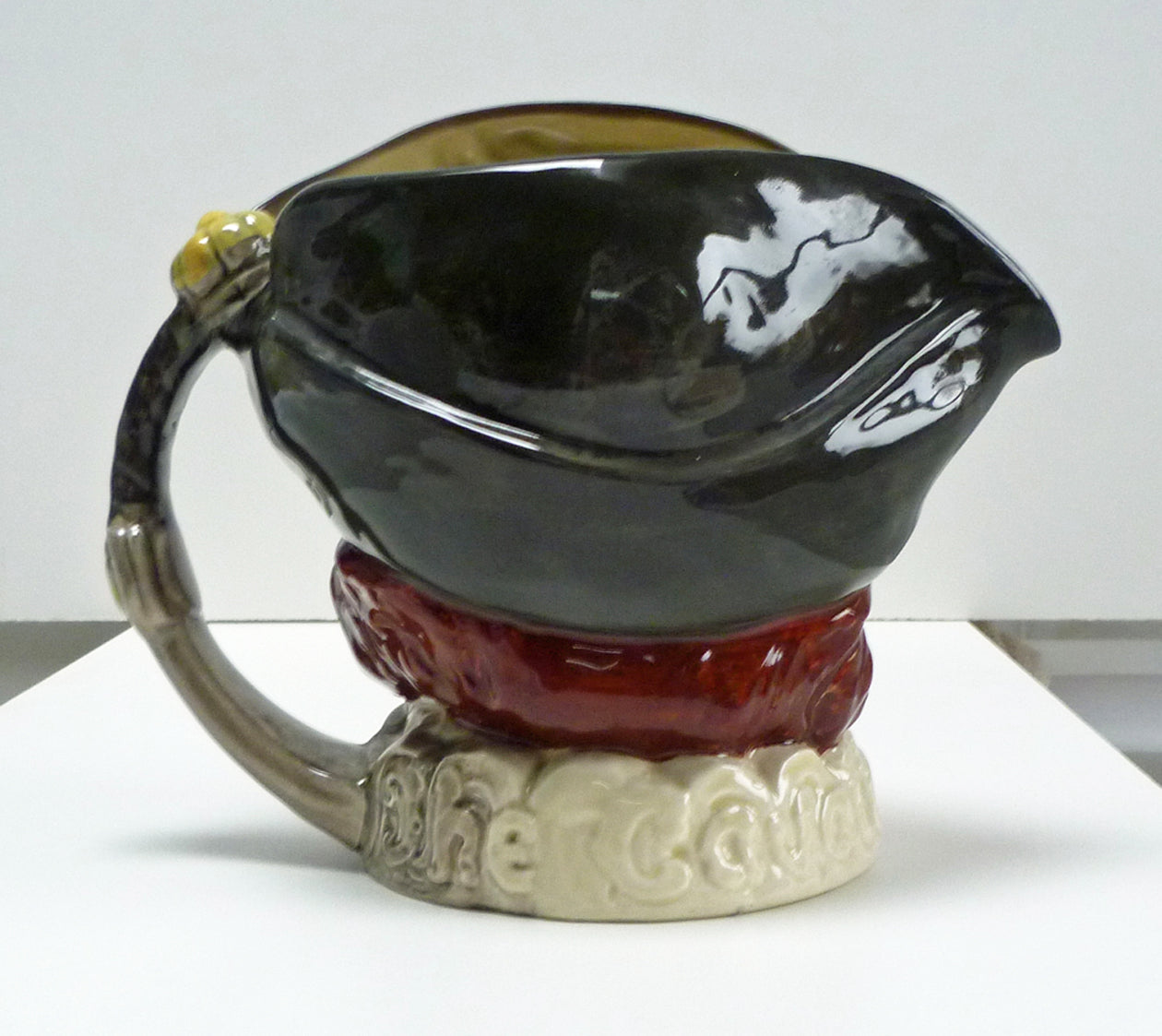 Handle and back of figure head of a Royal Doulton Cavalier jug.