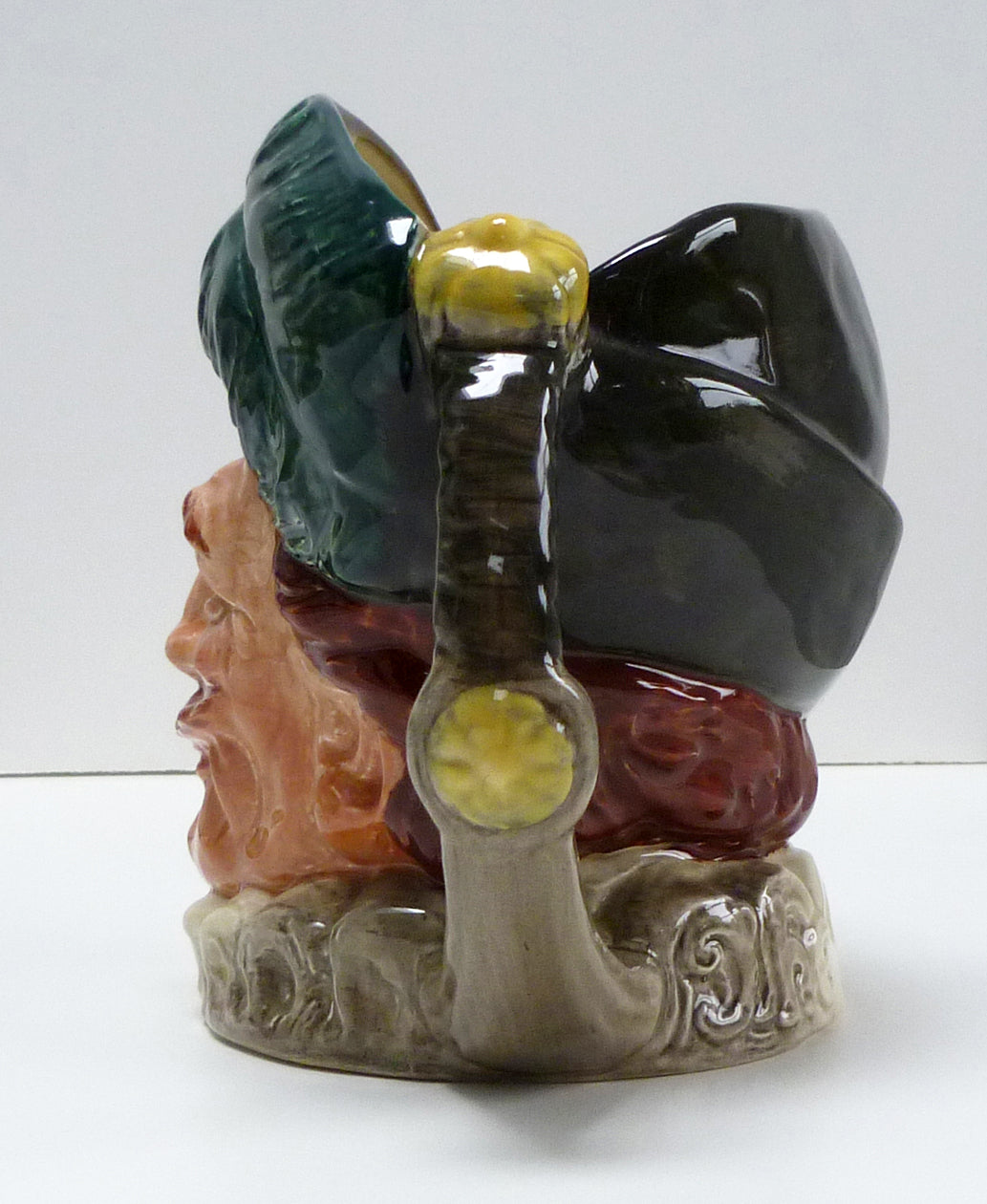 Left side of head and handle of a large Royal Doulton Cavalier jug.