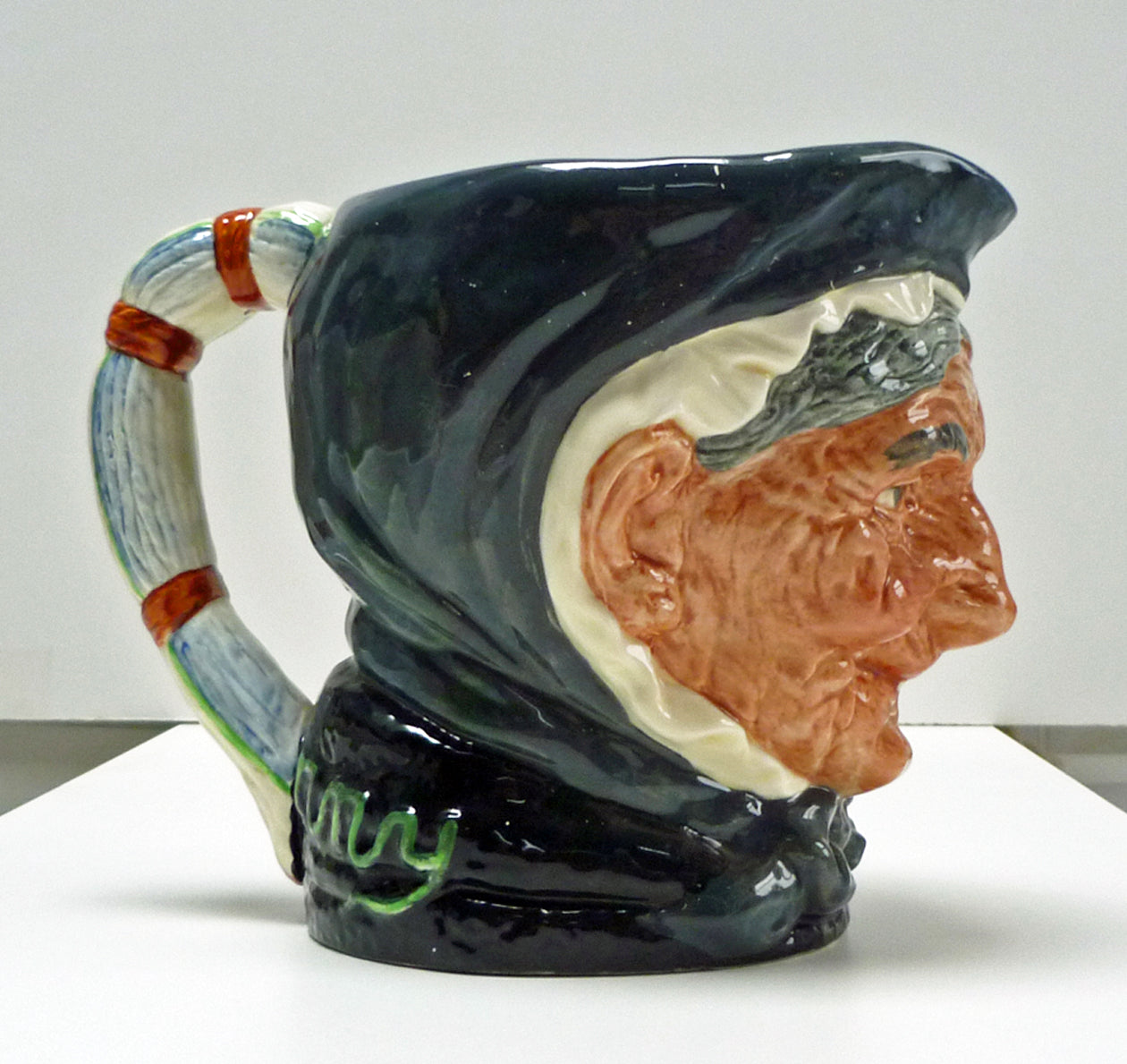 Right side of a large Royal Doulton single toothed Granny jug.