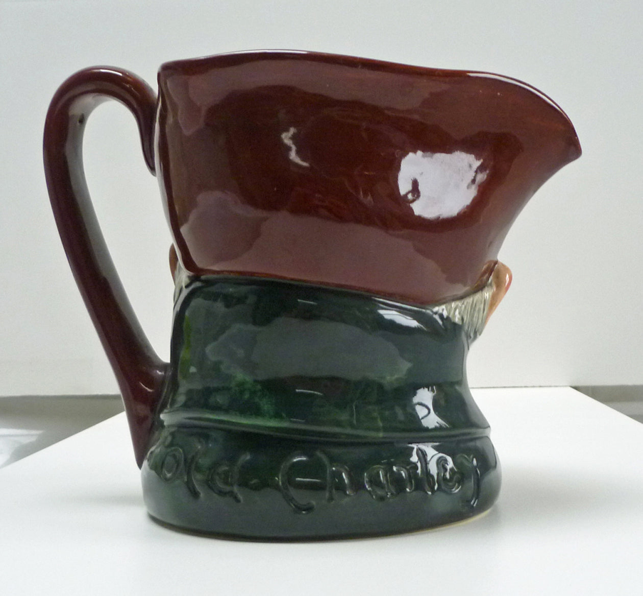Handle and back of figure head of a Royal Doulton Old Charley jug.