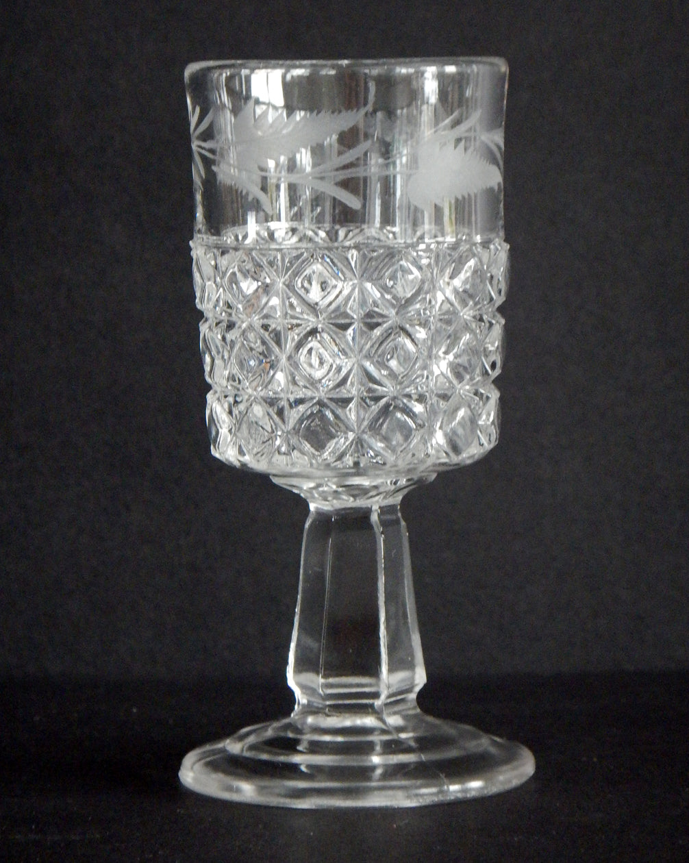 Close-up of blocks and etched fern on a cordial in Mascotte pattern.