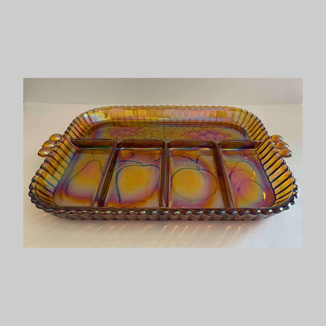 Vintage gold Indiana glass relish tray, with five sections and fruits in the pattern.