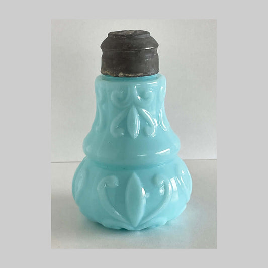 Antique blue pressed milk glass salt shaker in the Creased Waist pattern.