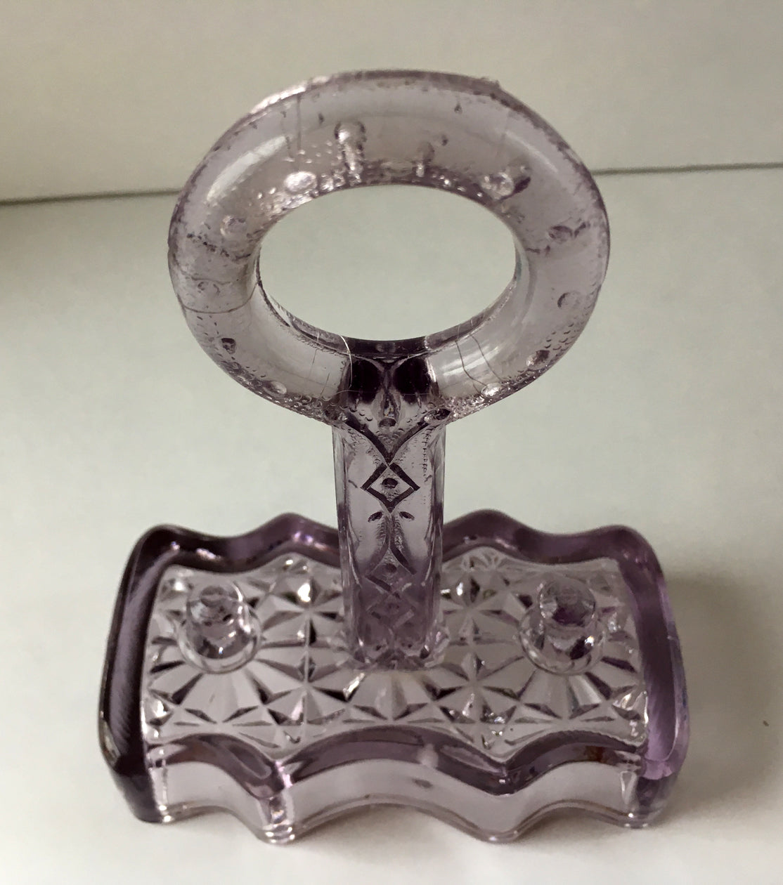 Antique pressed glass salt and pepper shaker holder in clear glass.