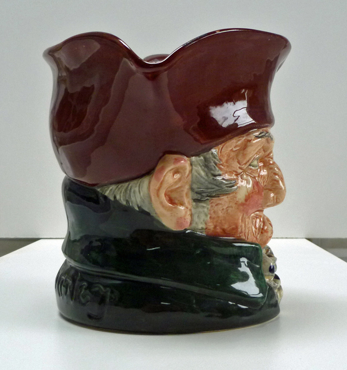 Right side of a figure head of a large Royal Doulton Old Charley jug. 