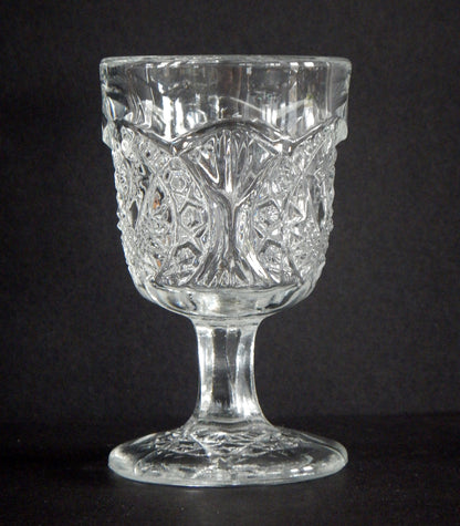 Close-up of pattern glass cordial with Arrowhead and Oval details in glass.  