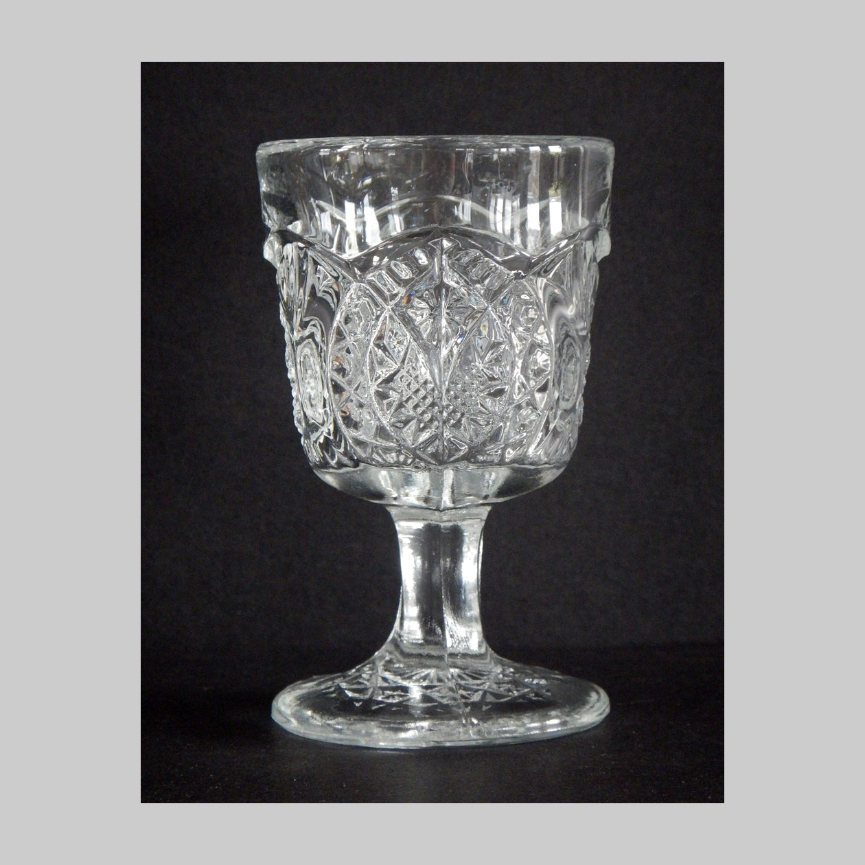 Antique clear pressed glass cordial in Arrowhead and Oval pattern and details.