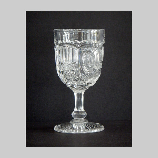 Antique clear pressed glass cordial in the Liberty pattern.