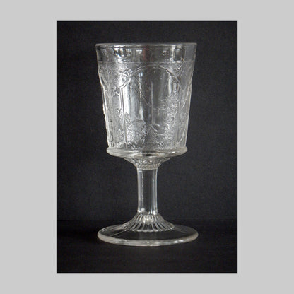 Antique pressed glass goblet in Canadian pattern with mountain country scene.