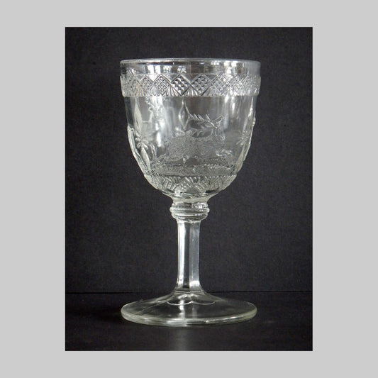 Antique clear pressed glass goblet in Elk and Doe pattern.