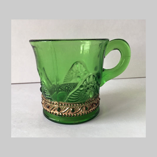 Antique pressed green glass child’s mug, Jewel pattern, with gold scroll around base.