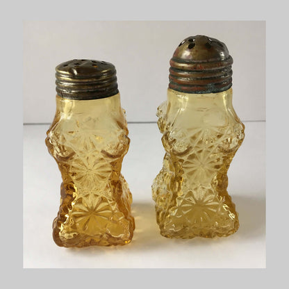 Antique pressed amber coloured glass, salt and pepper, with Daisy and Button pattern.