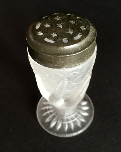 Close-up showing the lid design with stars on a frosted glass salt shaker. 