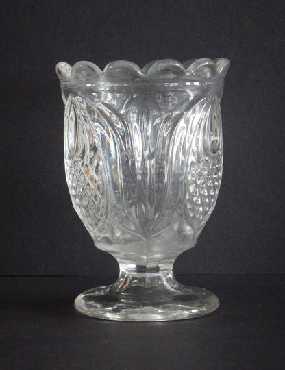 Close-up of scalloped edge glass details on a spoon holder in Pineapple pattern.