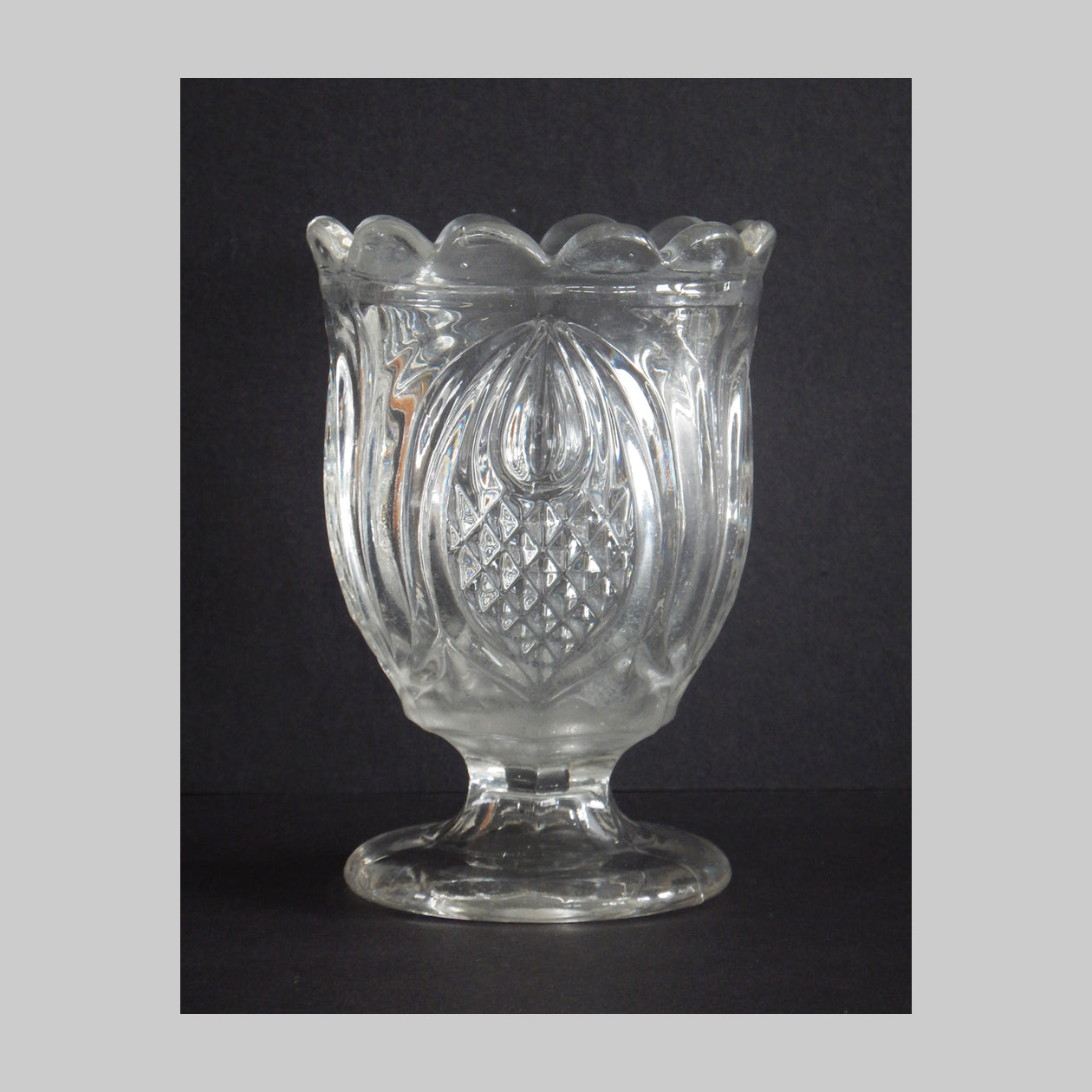 Antique pressed glass spooner in Pineapple pattern.