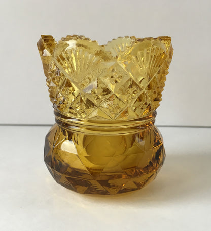 Close-up of a pressed glass toothpick holder in Westmoreland sixty pattern.