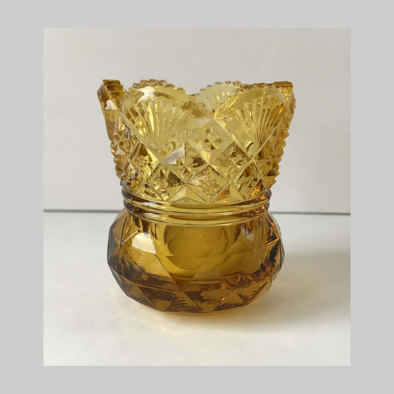 Antique amber pressed glass toothpick holder in Westmoreland sixty pattern.