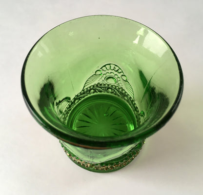 Looking into the inside of a green glass toothpick holder in the Jewel pattern.