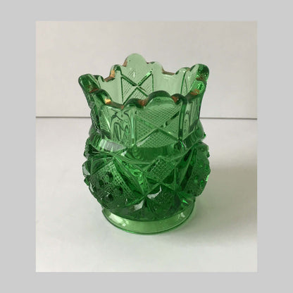 Antique green pressed glass toothpick holder in sunbeam pattern.